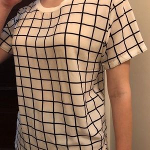 Feels like rayon or polyester and loose size small